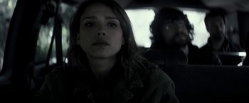 Movie still from “The Veil” (2016), directed by Phil Joanou – A young woman sitting in the back seat of a car; Close Up shot, Over the shoulder angle