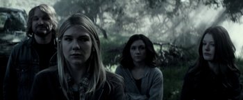 Movie still from “The Veil” (2016), directed by Phil Joanou – Two women standing next to each other in the woods; Medium shot, Low angle