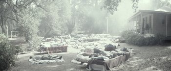 Movie still from “The Veil” (2016), directed by Phil Joanou – Blankets are laid out on the ground in the fog; Extreme Wide shot, High angle