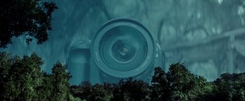 Movie still from “The Veil” (2016), directed by Phil Joanou – A camera with trees in the background; Extreme Close Up shot, Overhead angle
