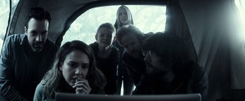 Movie still from “The Veil” (2016), directed by Phil Joanou – A group of people standing in the back of a car; Medium shot, Over the shoulder angle