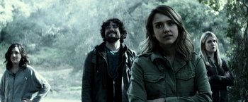 Movie still from “The Veil” (2016), directed by Phil Joanou – A man and a woman standing next to each other in front of trees; Close Up shot, Over the shoulder angle