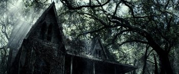 Movie still from “The Veil” (2016), directed by Phil Joanou – An old house in the middle of a forest; Extreme Wide shot, Low angle