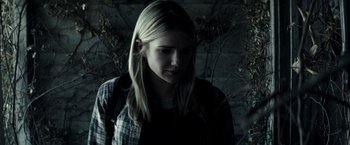 Movie still from “The Veil” (2016), directed by Phil Joanou – A woman with long blonde hair wearing a checkered shirt; Close Up shot, Over the shoulder angle