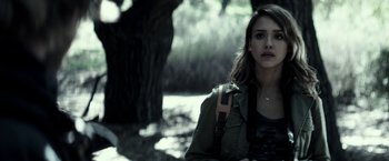 Movie still from “The Veil” (2016), directed by Phil Joanou – A young woman holding a camera in front of a tree; Close Up shot, Over the shoulder angle