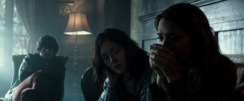 Movie still from “The Veil” (2016), directed by Phil Joanou – Two people sitting in a room with a lamp in the background; Close Up shot, Over the shoulder angle