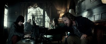 Movie still from “The Veil” (2016), directed by Phil Joanou – A man and a woman are looking at a camera; Medium shot, Over the shoulder angle