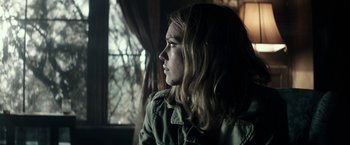Movie still from “The Veil” (2016), directed by Phil Joanou – A woman with long hair looking out of a window; Close Up shot, Over the shoulder angle
