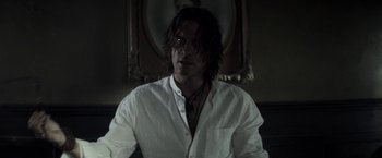 Movie still from “The Veil” (2016), directed by Phil Joanou – A man with long hair wearing a white dress shirt; Close Up shot, Over the shoulder angle