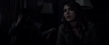 Movie still from “The Veil” (2016), directed by Phil Joanou – A woman sitting in front of a lamp in a dark room; Close Up shot, Over the shoulder angle