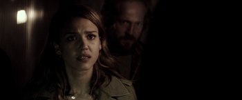 Movie still from “The Veil” (2016), directed by Phil Joanou – A woman standing next to a man in a dark room; Close Up shot, Over the shoulder angle