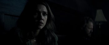 Movie still from “The Veil” (2016), directed by Phil Joanou – A woman with long dark hair stares into the camera; Close Up shot, Over the shoulder angle