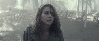 Movie still from “The Veil” (2016), directed by Phil Joanou – A woman with long hair is standing in the fog; Close Up shot, Over the shoulder angle