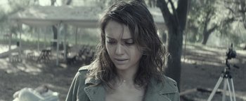 Movie still from “The Veil” (2016), directed by Phil Joanou – A young woman with long brown hair is crying; Close Up shot, Over the shoulder angle