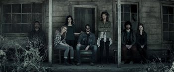 Movie still from “The Veil” (2016), directed by Phil Joanou – Three women and a man sitting on a porch; Wide shot, Low angle