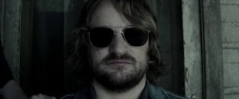 Movie still from “The Veil” (2016), directed by Phil Joanou – A person wearing sunglasses; Close Up shot, Low angle