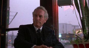 Movie still from “The Verdict” (1982), directed by Sidney Lumet – An older man wearing a suit and tie sitting in front of a window; Close Up shot, Low angle
