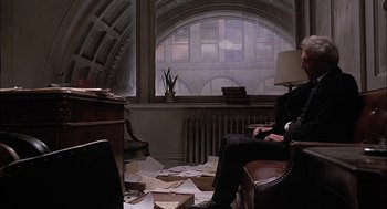 Movie still from “The Verdict” (1982), directed by Sidney Lumet – A man sitting on a chair in front of a window; Wide shot, High angle