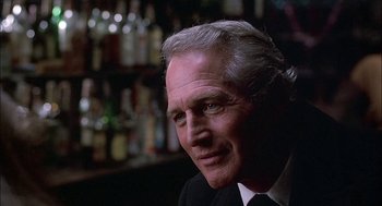 Movie still from “The Verdict” (1982), directed by Sidney Lumet – An older man wearing a suit and tie in front of a bar; Close Up shot, Over the shoulder angle