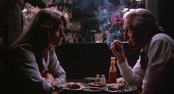 Movie still from “The Verdict” (1982), directed by Sidney Lumet – A man and a woman sitting at a table with food; Close Up shot, Low angle