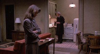 Movie still from “The Verdict” (1982), directed by Sidney Lumet – A man and a woman standing in a kitchen; Wide shot, High angle