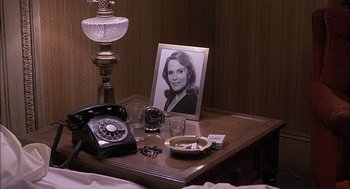 Movie still from “The Verdict” (1982), directed by Sidney Lumet – An old fashioned telephone and a picture on a table; Medium shot, High angle