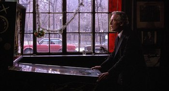 Movie still from “The Verdict” (1982), directed by Sidney Lumet – A man in a suit looking out of a window; Medium shot, Over the shoulder angle