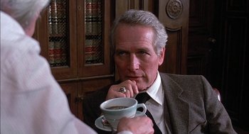 Movie still from “The Verdict” (1982), directed by Sidney Lumet – A man sitting at a table with a cup of coffee; Close Up shot, Over the shoulder angle