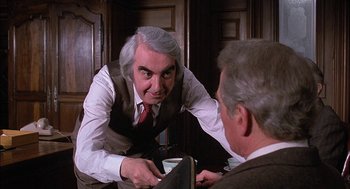 Movie still from “The Verdict” (1982), directed by Sidney Lumet – A man in a vest and tie is talking to another man in a suit and tie; Medium shot, Over the shoulder angle