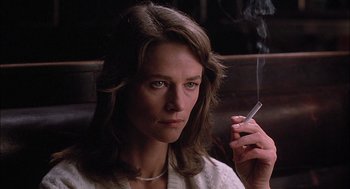 Movie still from “The Verdict” (1982), directed by Sidney Lumet – A woman sitting in a chair holding a cigarette in her hand; Close Up shot, Low angle