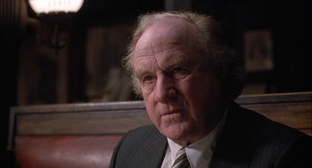 Movie still from “The Verdict” (1982), directed by Sidney Lumet – An older man wearing a suit and tie; Close Up shot, Over the shoulder angle