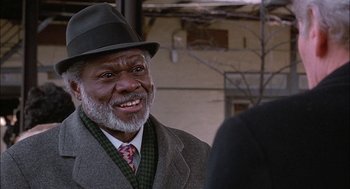 Movie still from “The Verdict” (1982), directed by Sidney Lumet – An older man wearing a suit and a hat; Close Up shot, Over the shoulder angle