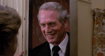 Movie still from “The Verdict” (1982), directed by Sidney Lumet – An older man wearing a suit and tie smiling; Close Up shot, Low angle