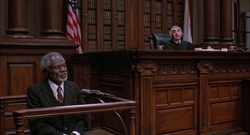 Movie still from “The Verdict” (1982), directed by Sidney Lumet – Two men in suits and gowns in a court room; Medium shot, High angle