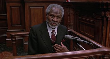 Movie still from “The Verdict” (1982), directed by Sidney Lumet – An older man wearing a suit in a court room; Close Up shot, High angle