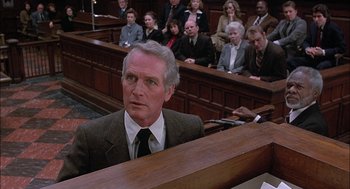 Movie still from “The Verdict” (1982), directed by Sidney Lumet – A man in a courtroom with a crowd of people watching; Medium shot, High angle
