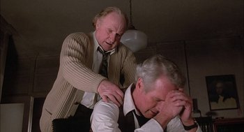 Movie still from “The Verdict” (1982), directed by Sidney Lumet – Two older men in a room with one of them holding his head down; Close Up shot, Over the shoulder angle