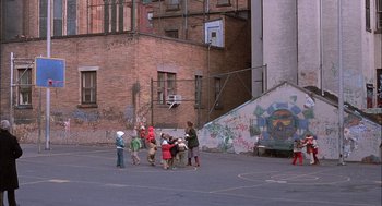 Movie still from “The Verdict” (1982), directed by Sidney Lumet – A group of children playing basketball on a court; Wide shot, High angle