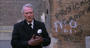 Movie still from “The Verdict” (1982), directed by Sidney Lumet – An older man in a suit and tie standing in front of a brick wall; Close Up shot, Low angle