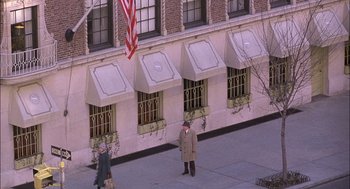 Movie still from “The Verdict” (1982), directed by Sidney Lumet – Two people are standing in front of a building with awnings on it; Wide shot, Overhead angle