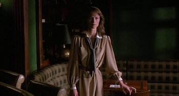 Movie still from “The Verdict” (1982), directed by Sidney Lumet – A woman standing in front of a couch in a living room; Medium shot, Low angle