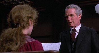 Movie still from “The Verdict” (1982), directed by Sidney Lumet – An older man in a suit and tie talking to an older woman; Close Up shot, Over the shoulder angle