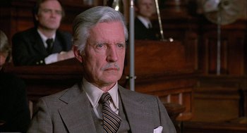 Movie still from “The Verdict” (1982), directed by Sidney Lumet – An older man wearing a suit and tie in front of a crowd of people; Close Up shot, High angle