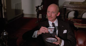 Movie still from “The Verdict” (1982), directed by Sidney Lumet – A man in a suit and tie holding a coffee cup; Close Up shot, Low angle