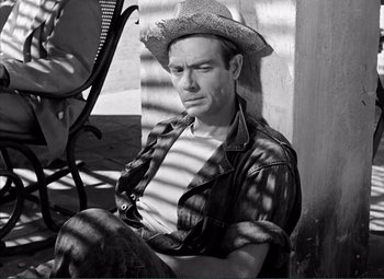 Movie still from “The Wages of Fear” (1953), directed by Henri-Georges Clouzot – A black and white photo of a man wearing a cowboy hat; Medium shot, High angle
