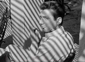 Movie still from “The Wages of Fear” (1953), directed by Henri-Georges Clouzot – Black and white photograph of a young man in a tie; Close Up shot, High angle