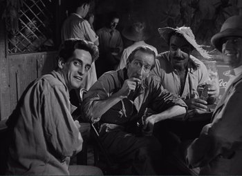 Movie still from “The Wages of Fear” (1953), directed by Henri-Georges Clouzot – A group of men sitting next to each other on a couch; Medium shot, High angle