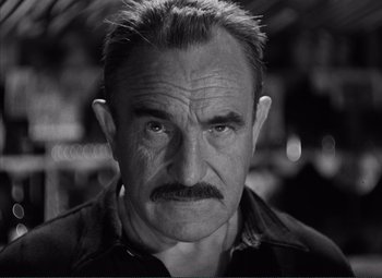 Movie still from “The Wages of Fear” (1953), directed by Henri-Georges Clouzot – Black and white photograph of a man with a mustache; Close Up shot, Low angle