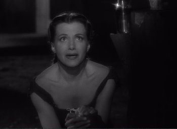 Movie still from “The Wages of Fear” (1953), directed by Henri-Georges Clouzot – A black - and - white photo of a woman looking up; Close Up shot, High angle