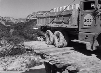 Movie still from “The Wages of Fear” (1953), directed by Henri-Georges Clouzot – A truck is parked on the side of the road; Wide shot, Low angle